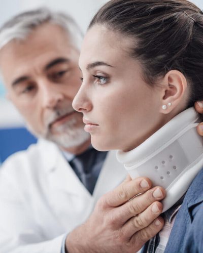 Doctor helping patient with neck injury.