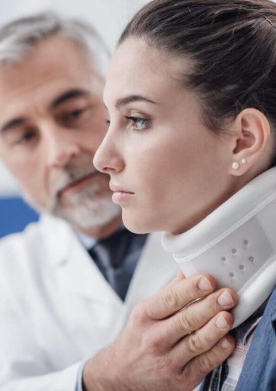 Doctor helping patient with neck injury.