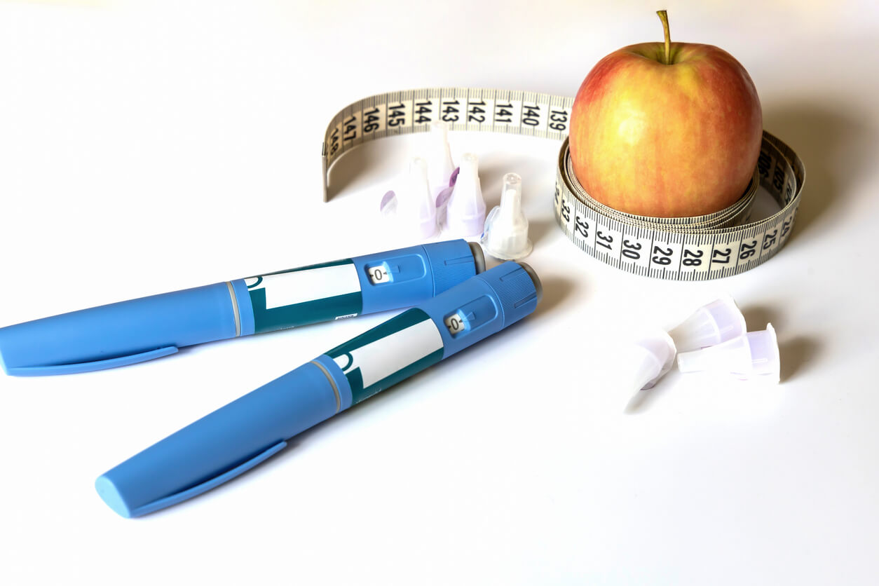Ozempic pen with an apple
