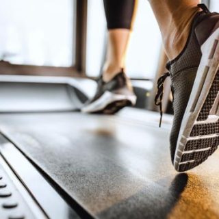 Person's shoes as they run on a treadmill