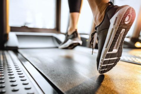 Person's shoes as they run on a treadmill