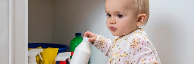 Baby handling chemical bottles