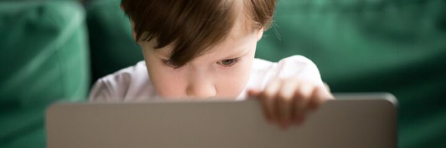 boy watching laptop screen