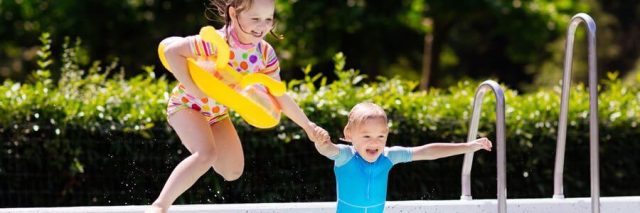 children jumping into a pool