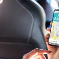 person in a car using a rideshare app