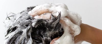 Person washing hair with shampoo