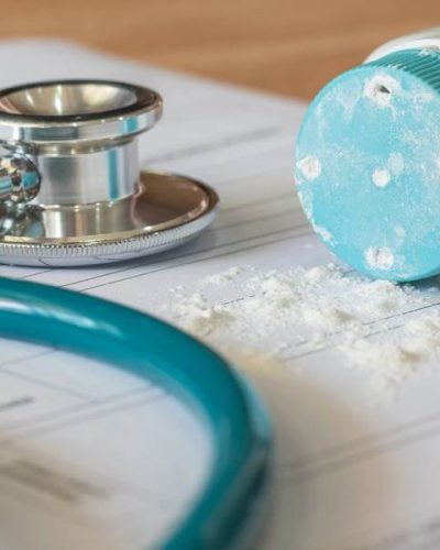 Stethoscope lying next to baby powder