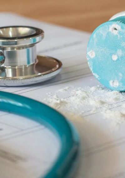 Stethoscope lying next to baby powder