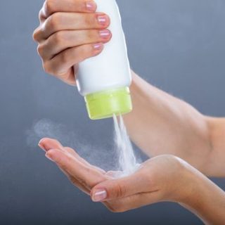 talcum powder being poured on a hand