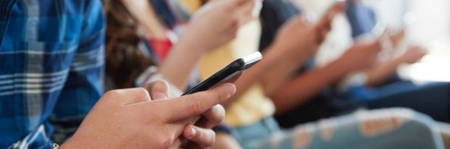 group of teens using their phones