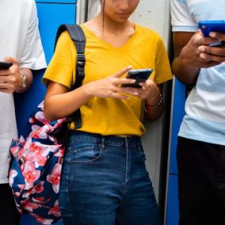 Teens looking at smartphones