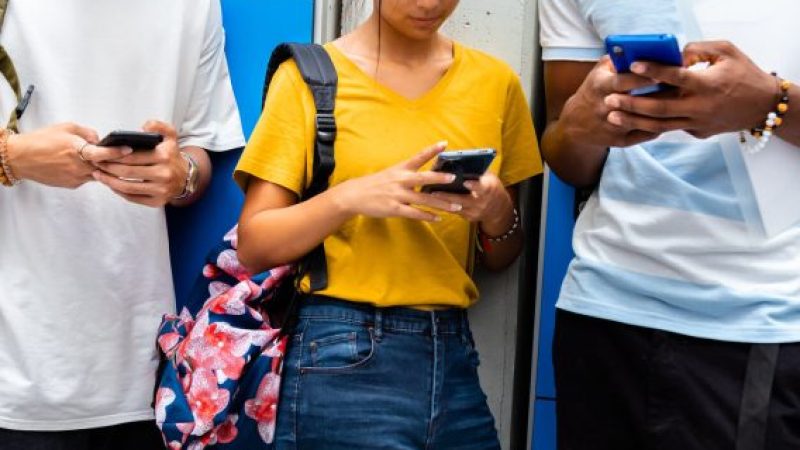 Teens looking at smartphones