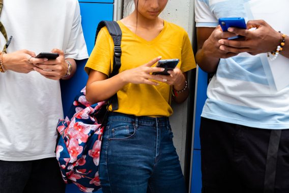 Teens looking at smartphones