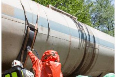 workers in hazmat suits doing maintenance on train