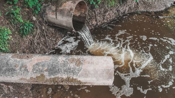 Water flowing from pipe into river