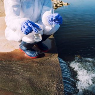 Person in protective gear testing water