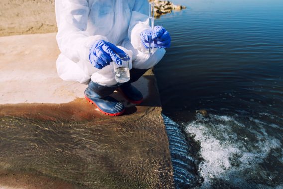 Person in protective gear testing water