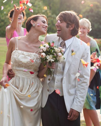 Happy married couple surrounded by family and friends