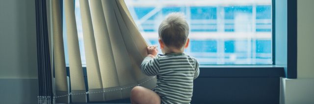 Baby staring out a window