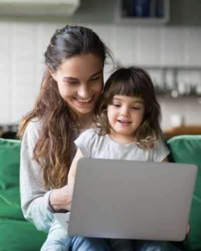 Woman and her young daughter using a laptop together