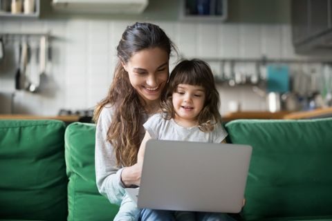 Woman and her young daughter using a laptop together