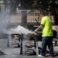 Worker cutting granite without protection.